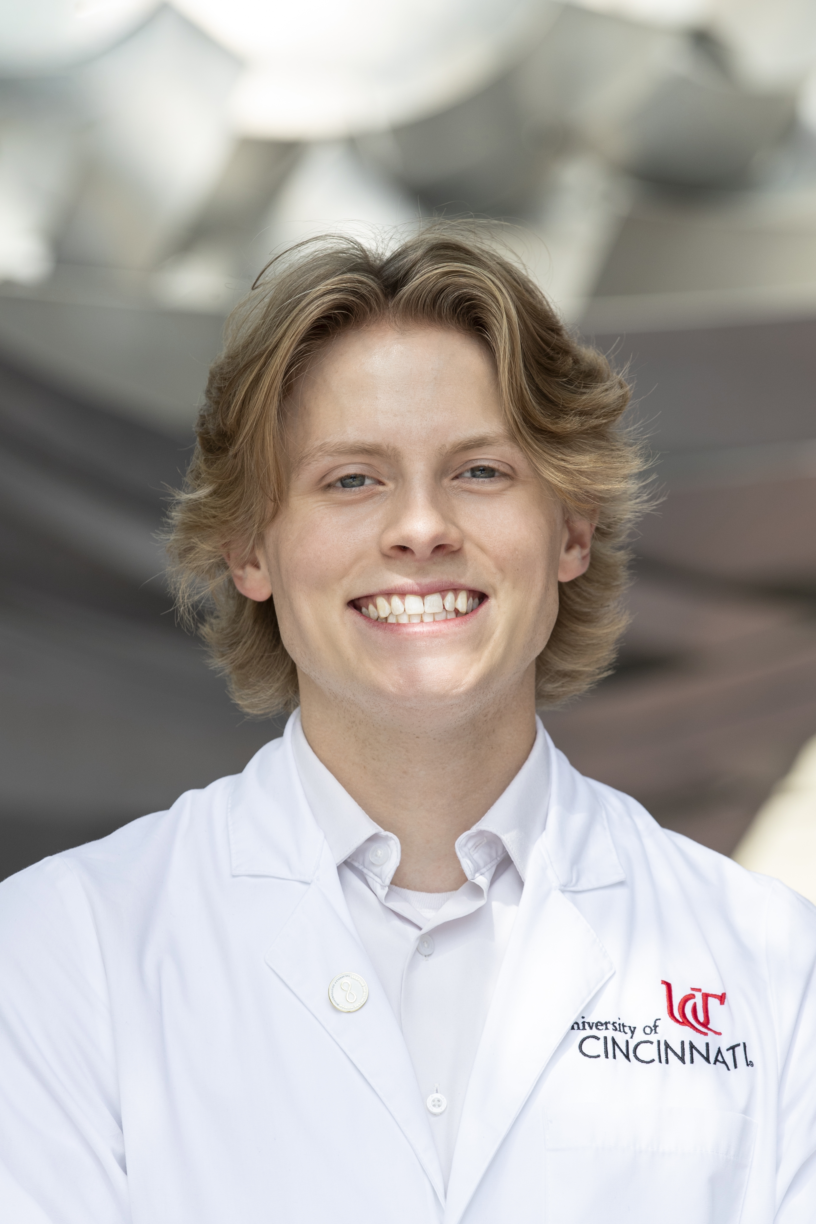 Lane Bokros wearing white coat.