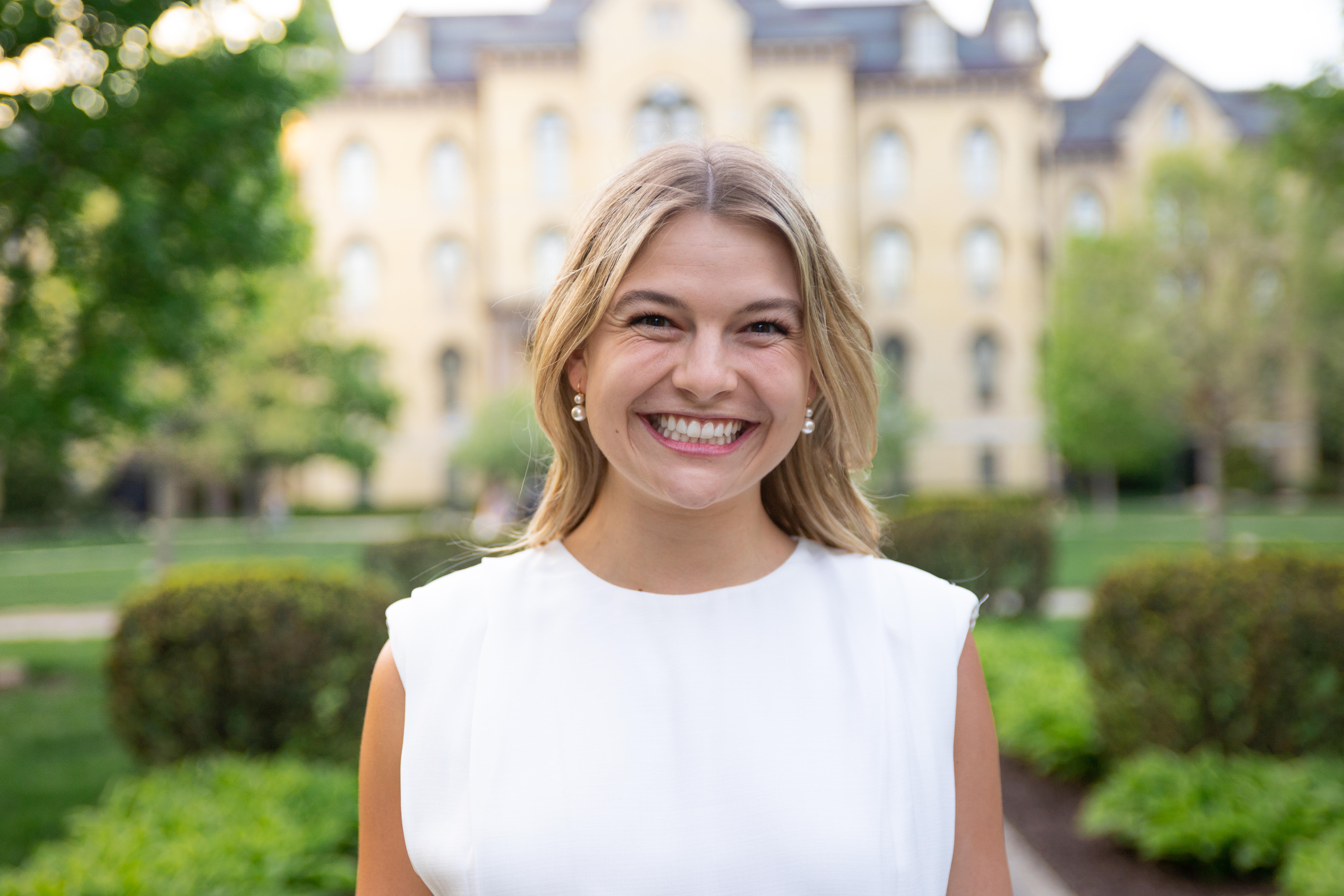 Anabele Konesco, outside, wearing white shirt.