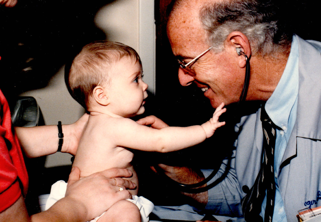 Roger Cole, MD, with pediatric patient