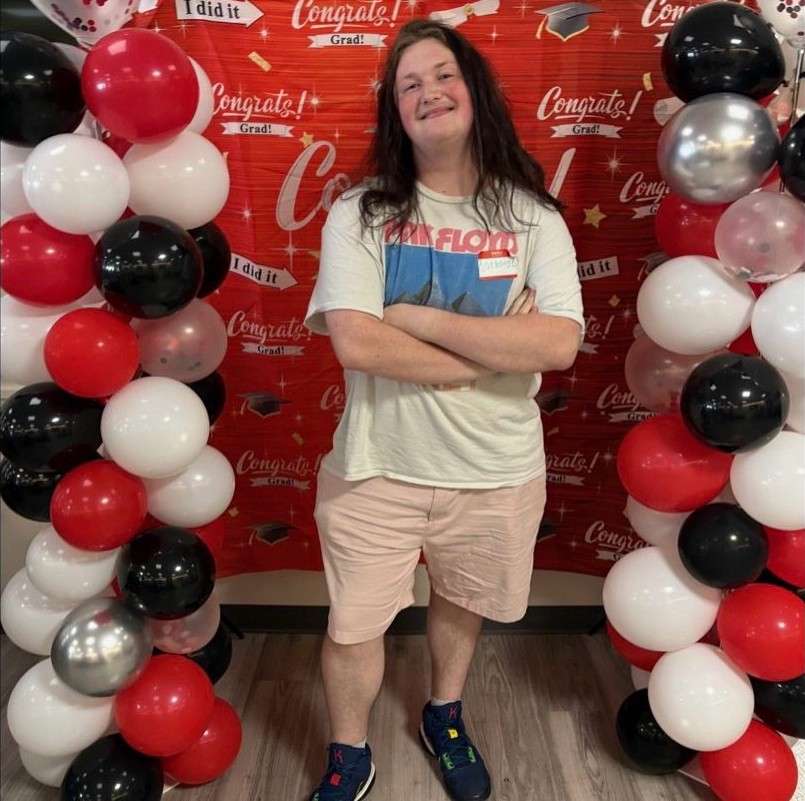 Anthony Brown celebrates transition from UC Blue Ash to UC's College of Arts and Sciences. He is pictured with red and white balloons. 