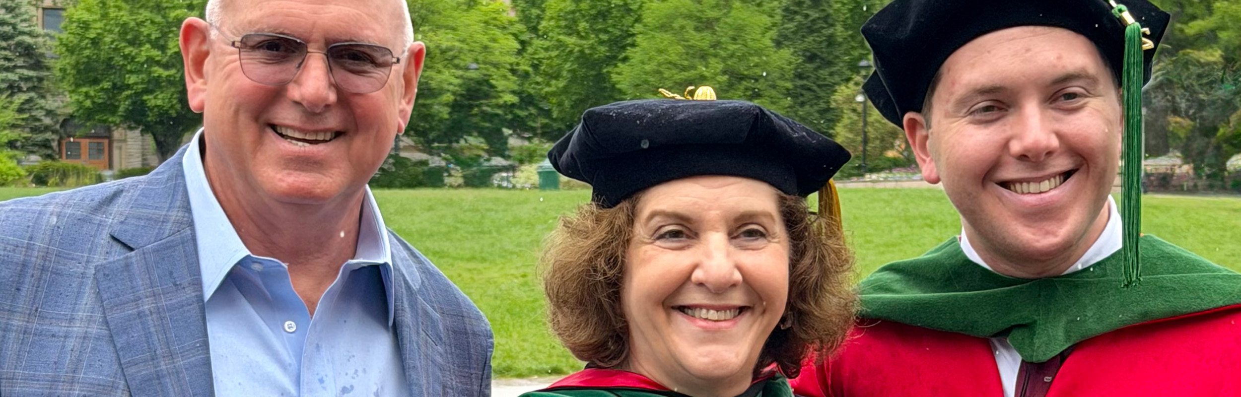 Rick Stamler, Betsy Rabkin and Ben Stamler. Betsy and Ben are wearing commencement robes.