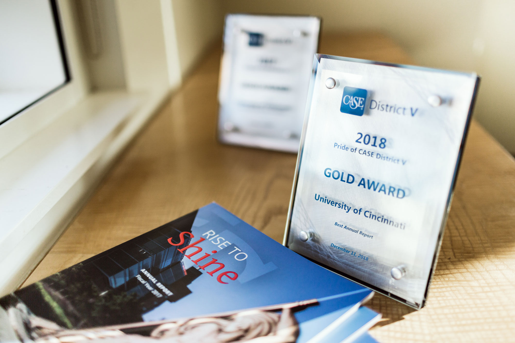 The two CASE Awards along with the award-winning annual report.