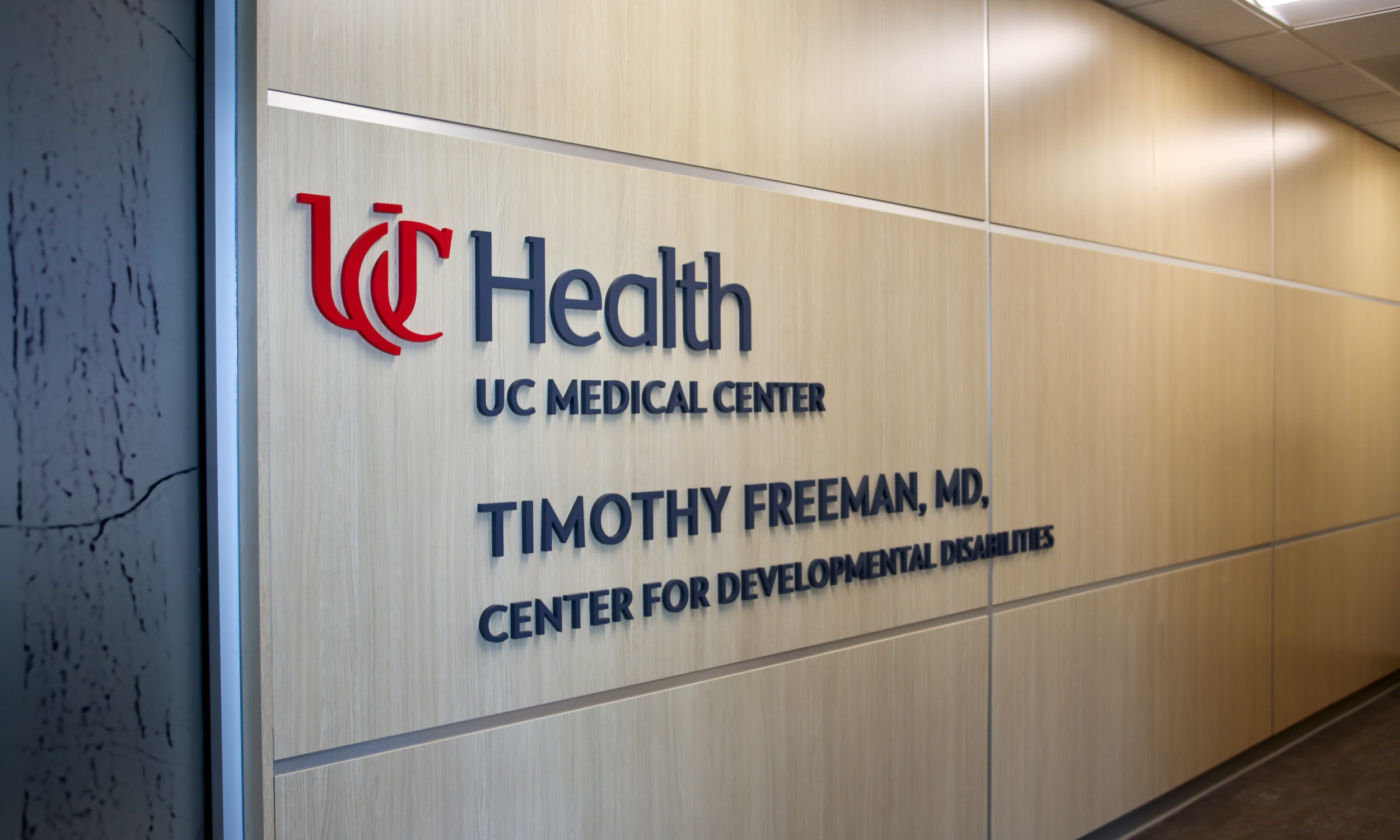 Signage reading UC Health UC Medical Center Timothy Freeman, MD, Center for Developmental Disabilities