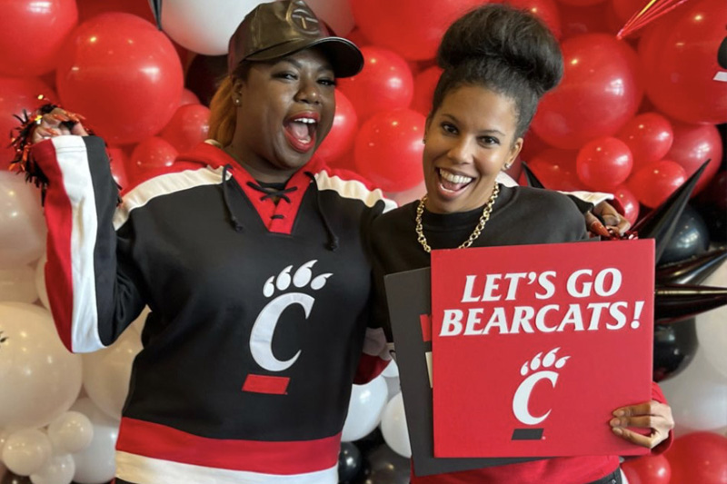 Patrice Barnes and Anndrea Moore holding Bearcat sign.